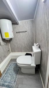 a bathroom with a white toilet in a room at Hospedaje Avenida in Puerto Montt +16 photos