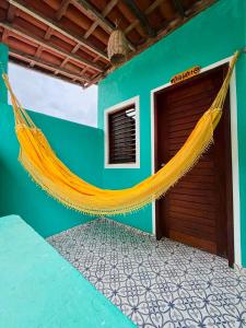 a hammock hanging on the side of a house at Casas Gica in Pipa
