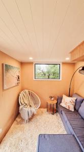 a living room with a couch and a window at The Tiny Diamond in Diamond Harbour
