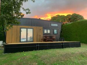 a tiny house with a picnic table in a yard at The Tiny Diamond in Diamond Harbour +13 photos