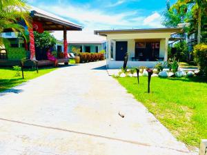 a walkway leading to a house with a yard at The Ideal Bed & Breakfast in Nadi
