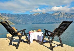 two chairs and a table with a view of the water at Step to Kotor bay St-oliv in Kotor