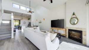 a living room with a white couch and a fireplace at Strand Way A by AvantStay in Oceano