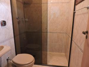 a shower stall with a toilet in a bathroom at Casa Do Sol in São Thomé das Letras