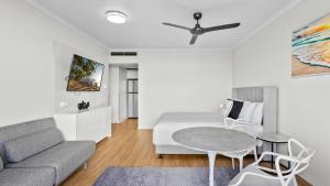 a living room with a bed and a table and a couch at The Studio at Northshore Tower in Cairns North