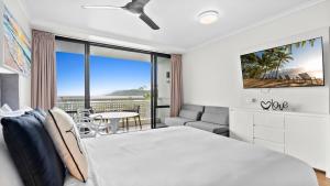 a bedroom with a bed and a view of the ocean at The Studio at Northshore Tower in Cairns North