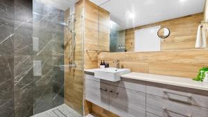 a bathroom with a sink and a shower at The Studio at Northshore Tower in Cairns North