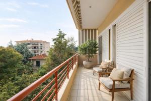a balcony with two chairs and a table at 3BR Suite 300mts from the Beach in Perea +7 photos