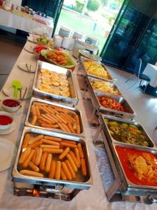 a buffet with many trays of food on a table at Ma Villa Khao Yai in Mu Si