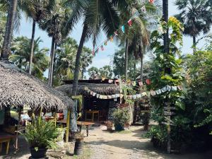 a resort with palm trees and flags and tables at Delft Village Stay - Experience Based Local Island Stay in Jaffna in Delft East