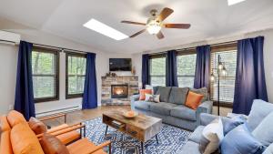 a living room with a couch and a fireplace at Moshannon by AvantStay in Pocono Lake