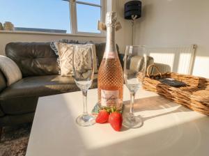 a bottle of champagne and two glasses on a table at The Nest in Bridlington +13 photos