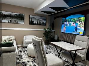 a living room with a tv and a table and chairs at apartment unit in Spokane