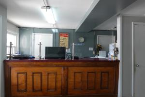 a bar with a wooden counter in a room at Cascades Motel - Chattanooga in Chattanooga