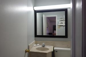 a bathroom with a sink and a mirror at Cascades Motel - Chattanooga in Chattanooga +69 photos