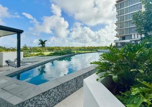 a swimming pool in the middle of a building at Bokarina Beachfront Penthouse - Oceanfront Luxury with Exclusive Rooftop Pool & Steam Room in Bokarina
