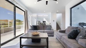 a living room with a couch and a table at Strand Way B by AvantStay in Oceano