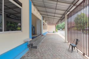 an empty hallway of a building with a chair at Graha Citra Cirebon in Cirebon +13 photos