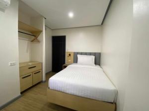 a small bedroom with a bed and a closet at GQ Apartment in Aklan