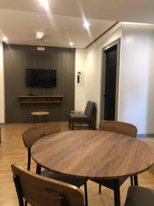 a room with a table and chairs and a television at GQ Apartment in Aklan +10 photos