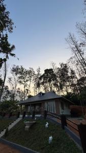 a house with a garden in front of it at Riverfolk Stays in Thodupuzha +5 photos