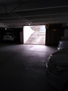 a dark room with a car parked in a garage at Flat Apartamento Mobiliado na Prata in Campina Grande