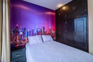a bedroom with a city skyline mural on the wall at Luxury Penthouse in Tuxpan