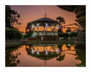 a night view of a building with a reflection in a pond at Luxury Penthouse in Tuxpan