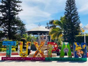 a sign in front of a park with a gazebo at Luxury Penthouse in Tuxpan
