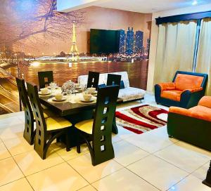 a dining room with a table and chairs and a television at Luxury Penthouse in Tuxpan