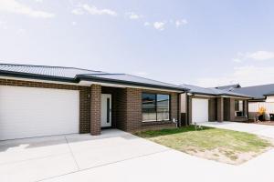 a brick house with a garage at King Bed, 3 Beds, 2 bath, Sleeps 6 in Sale