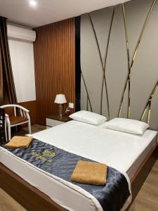 a bedroom with a large bed with two towels on it at Ruby 25 Hotel in Hà Ðông +11 photos