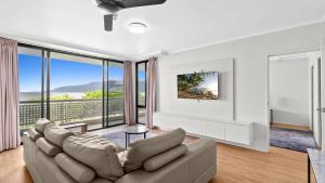 a living room with a couch and large windows at The Condo at Northshore Tower in Cairns North +23 photos