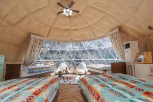a room with two beds and a large window at Morethan Paradise in Nagatoro