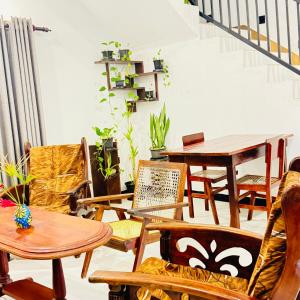 a room with chairs and a table and a table and chairs at Nila Villa & Homestay in Galle
