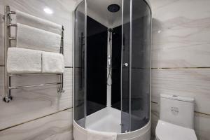 a glass shower in a bathroom with a toilet at Mumtoz Hotel in Samarkand +25 photos