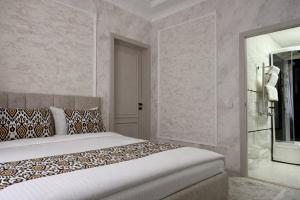 a bedroom with a bed and a walk in shower at Mumtoz Hotel in Samarkand