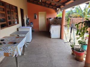 a patio with appliances and a table and a house at Encanto da Rosa in Cavalcante