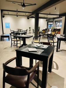 a restaurant with tables and chairs in a room at Seaport Negombo in Negombo