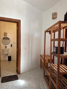 a room with a ladder and a mirror and a bathroom at Jumbo Resort in Paje