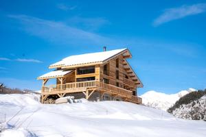 a log cabin in the snow with snow at Chalet 1480 in Allos