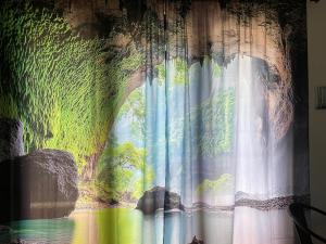 a curtain with a painting of a river at Casa Fabiana in Lemos