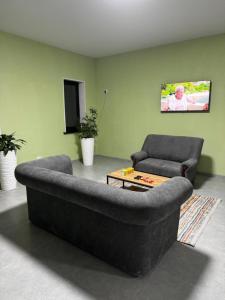 a living room with a couch and a table at HOSTEL Q7 Almaty in Almaty