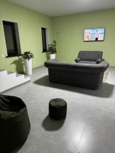 a living room with a couch and a ottoman at HOSTEL Q7 Almaty in Almaty +6 photos