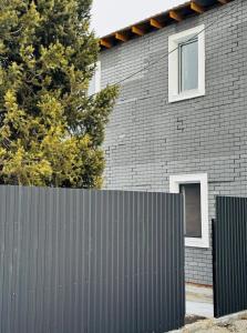 a black fence in front of a house at HOSTEL Q7 Almaty in Almaty