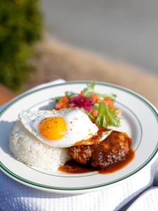 a plate of food with a fried egg and rice at Beach Front Seretis in Shimoda +44 photos