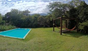 a swing and a swimming pool in a yard at La Casa Azul in San Javier