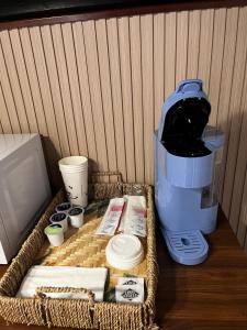 a table with a wicker basket with a coffee maker at Sequoia Village in Three Rivers