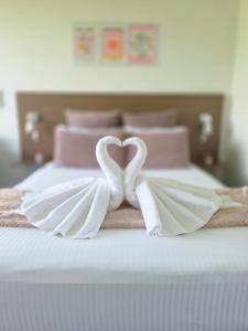 a bed with a heart made out of white towels at The Select Inn Ryde in Sydney +89 photos