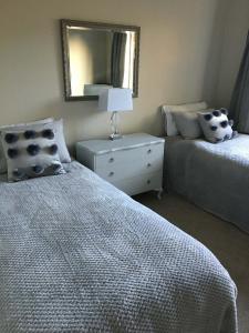 a bedroom with a bed and a dresser with a mirror at Private Retreat in Cambridge +10 photos